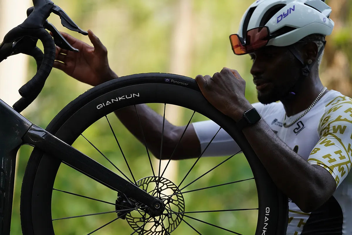 Rider inspecting deep carbon wheel