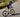Cyclist climbing out of the saddle on Yoeleo carbon wheelset showing rotating mass benefit