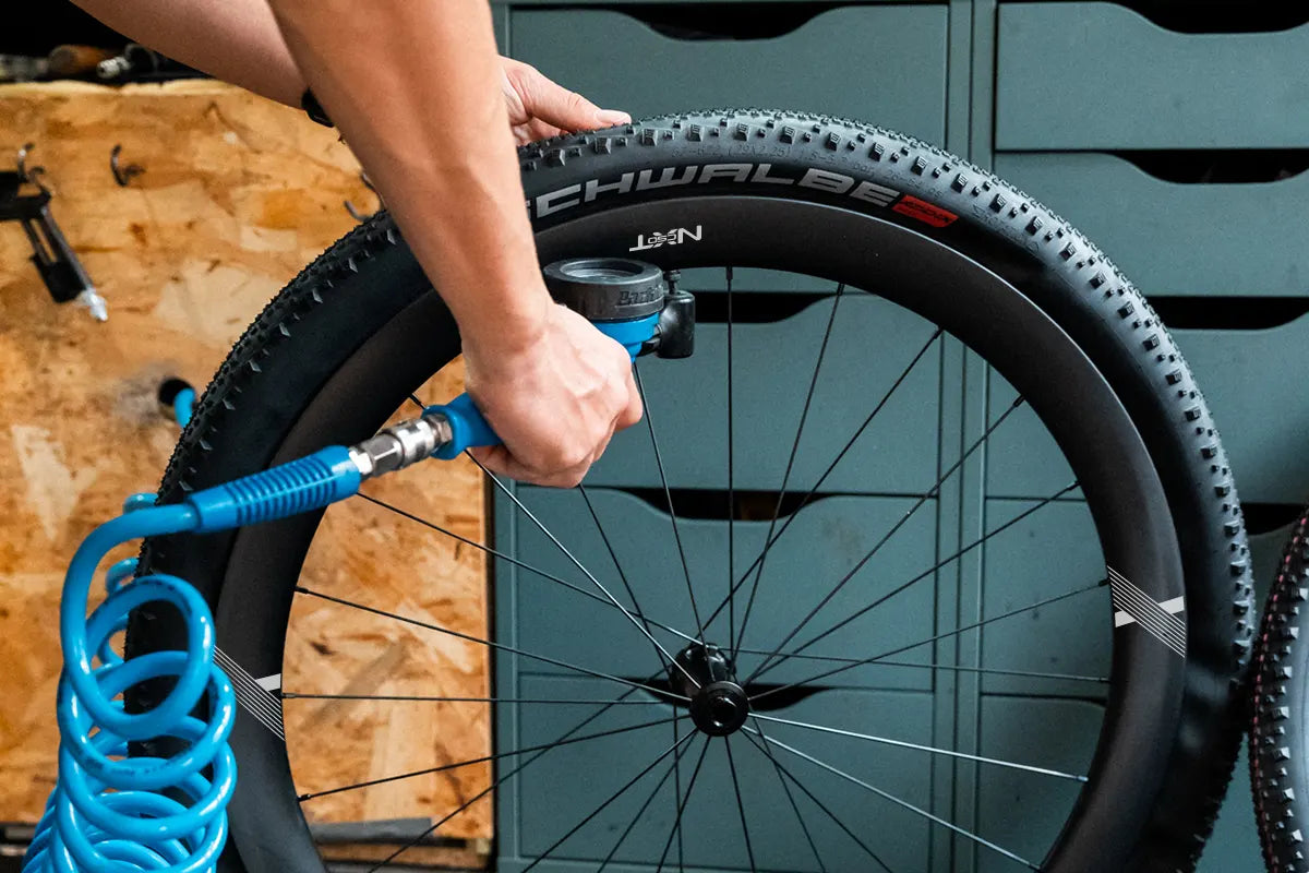 Rider inflating the gravel tire for the correct preassure point